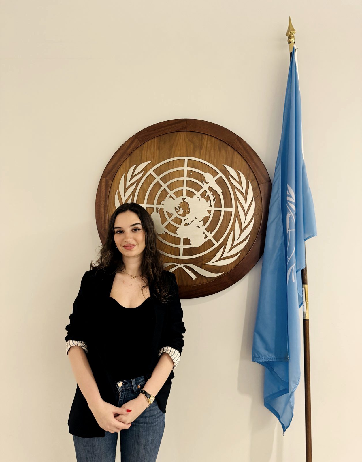 A Fellow's portrait beside the United Nations emblem